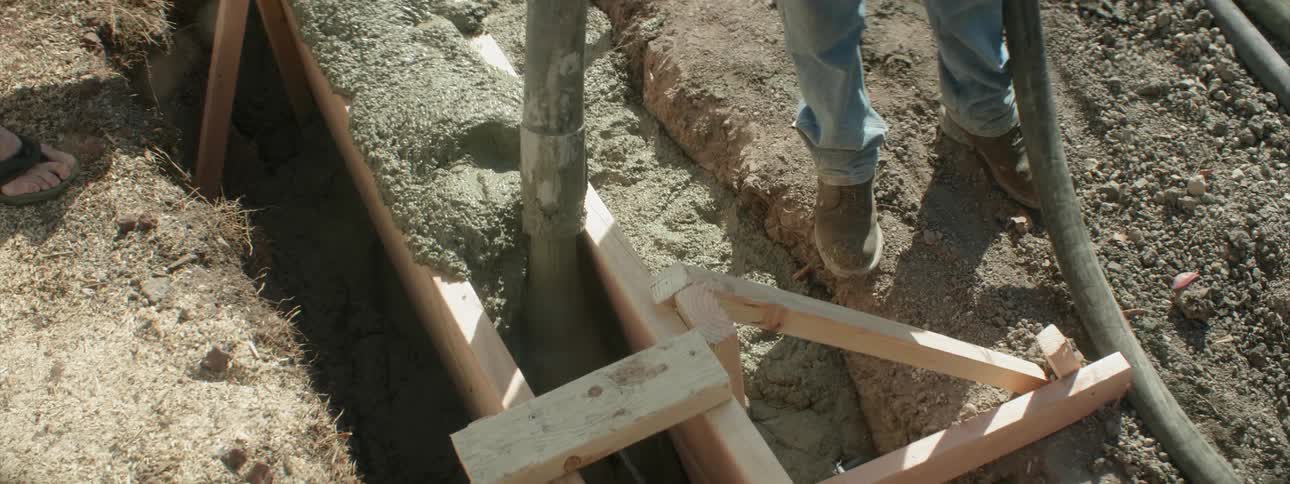 Concrete is poured at a construction site