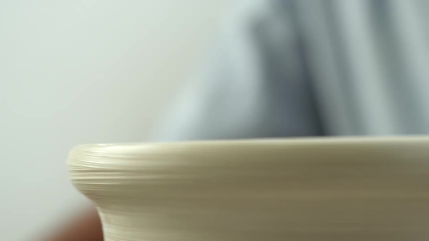 Formed clay spin on a potter's wheel