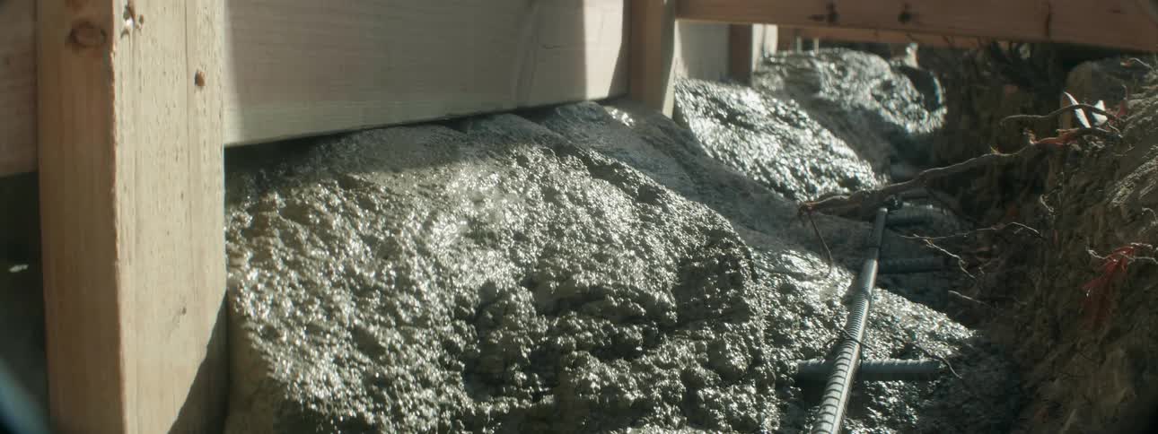 Concrete is poured at a construction site