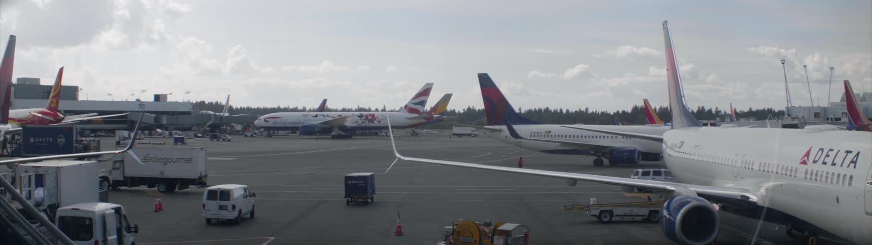 Airplanes and cars are driven on an airport tarmac