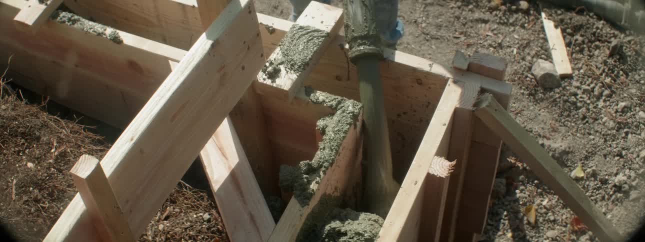 Concrete is poured at a construction site