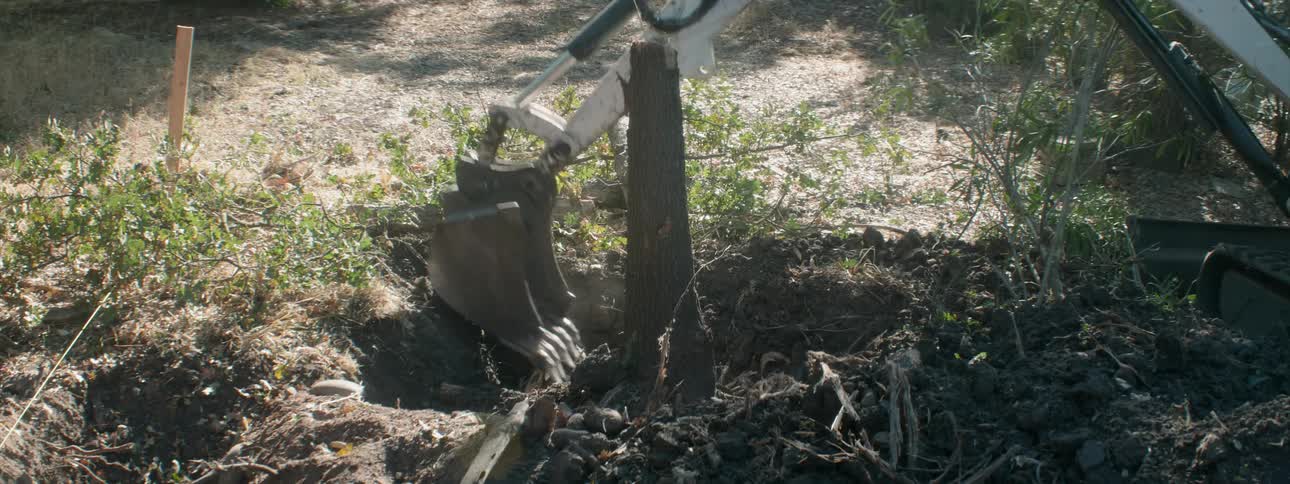 A digger excavates dirt at a job site