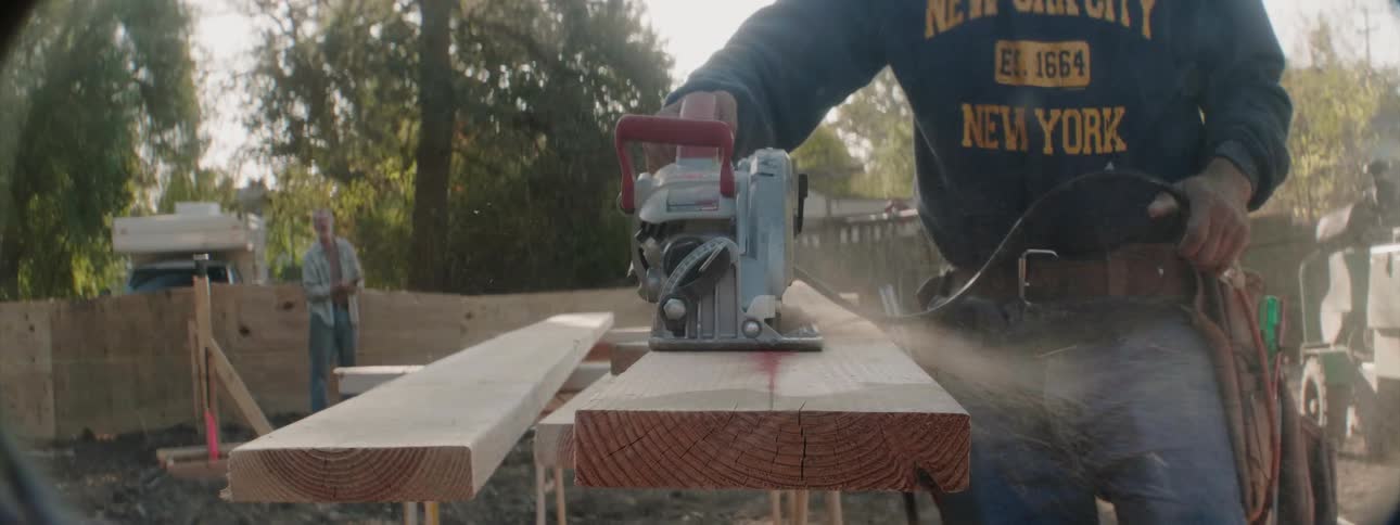 People are cutting boards on a sunny day