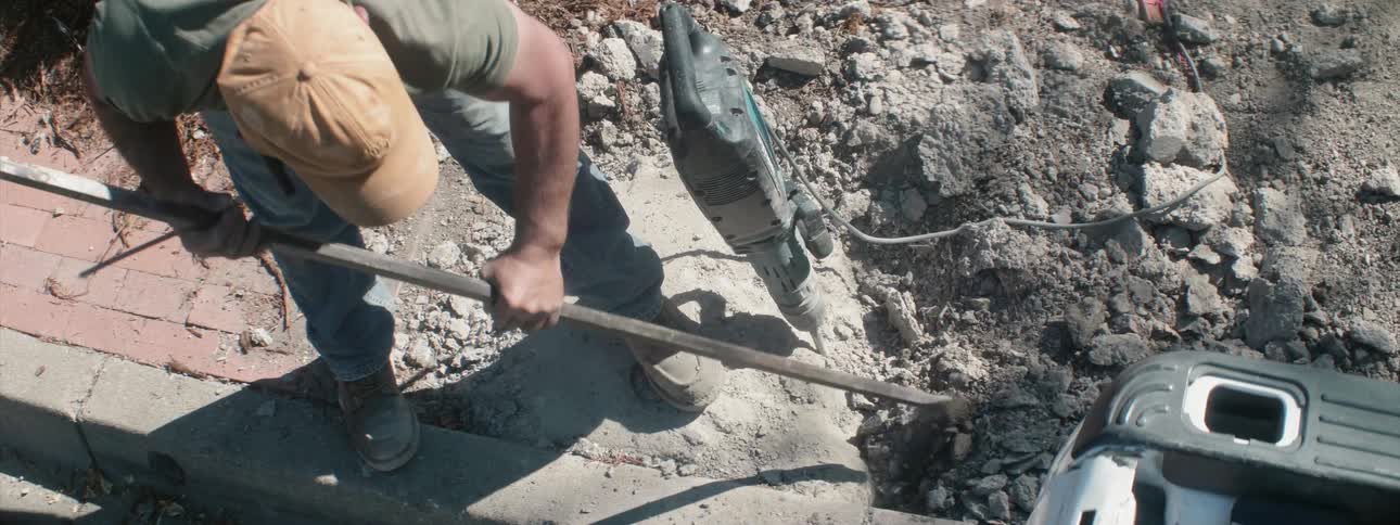 A construction worker digs at a job site