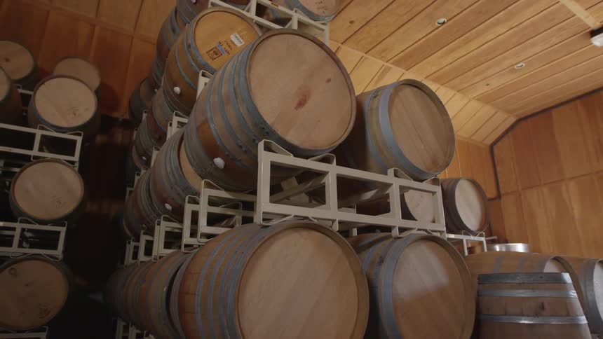 Barrels are aging in a warehouse