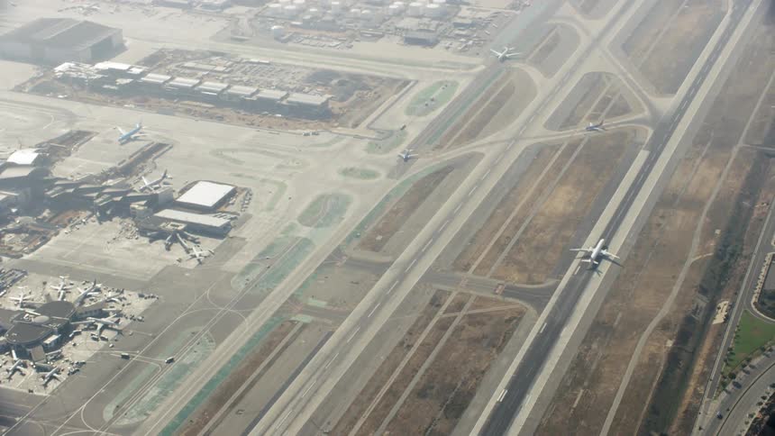 An airplane is taxiing down a runway on a sunny day