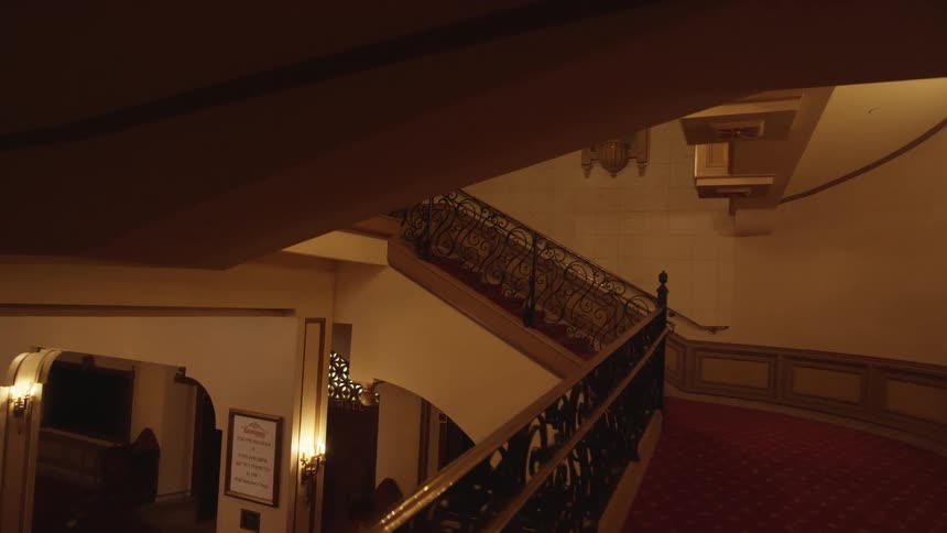 Moving up a large staircase in a building