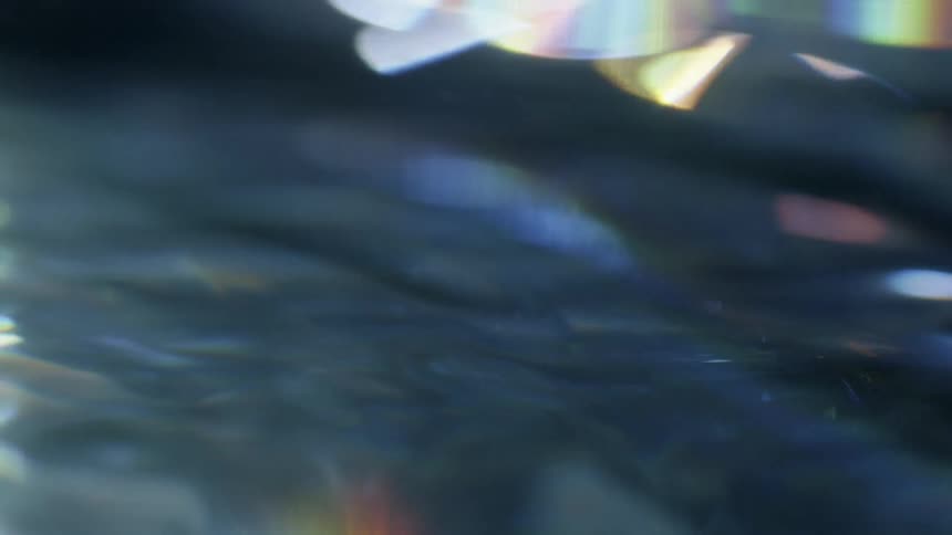The water is moving around reflecting light