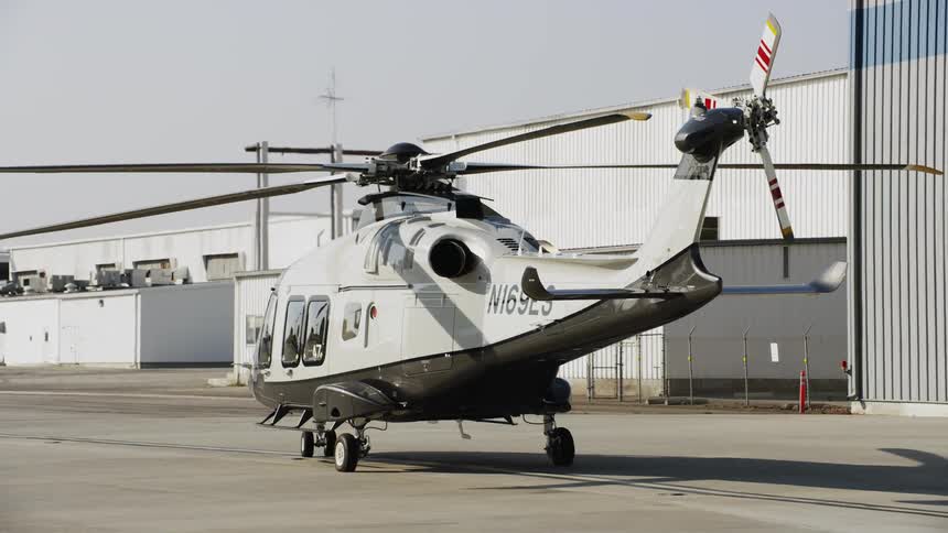 A large helicopter is parked on the runway