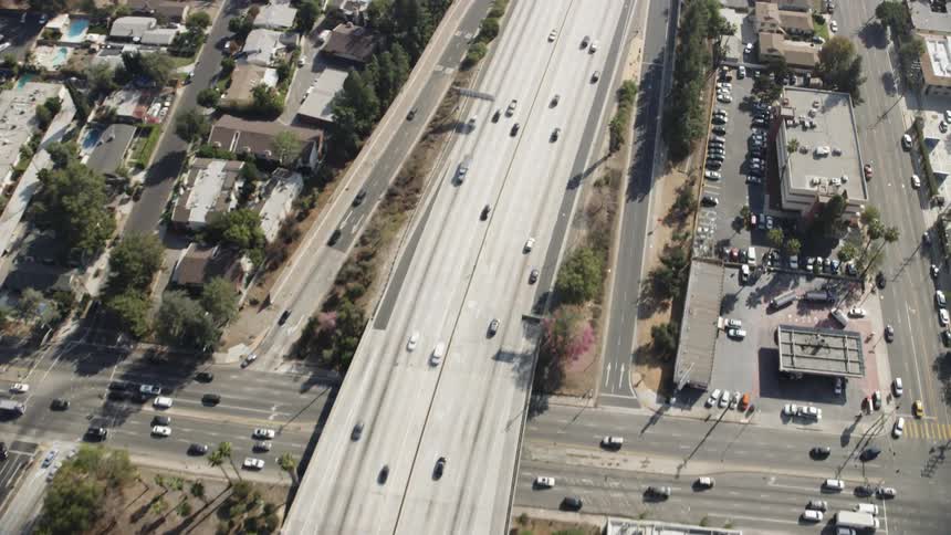 Cars drive on a city highway