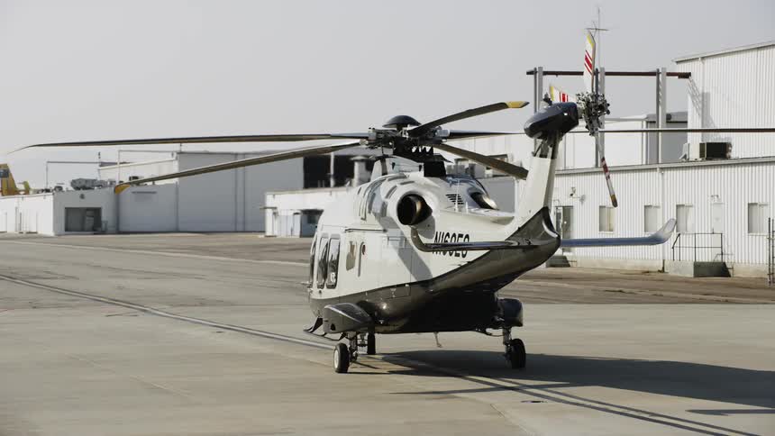 A helicopter is parked on a tarmac