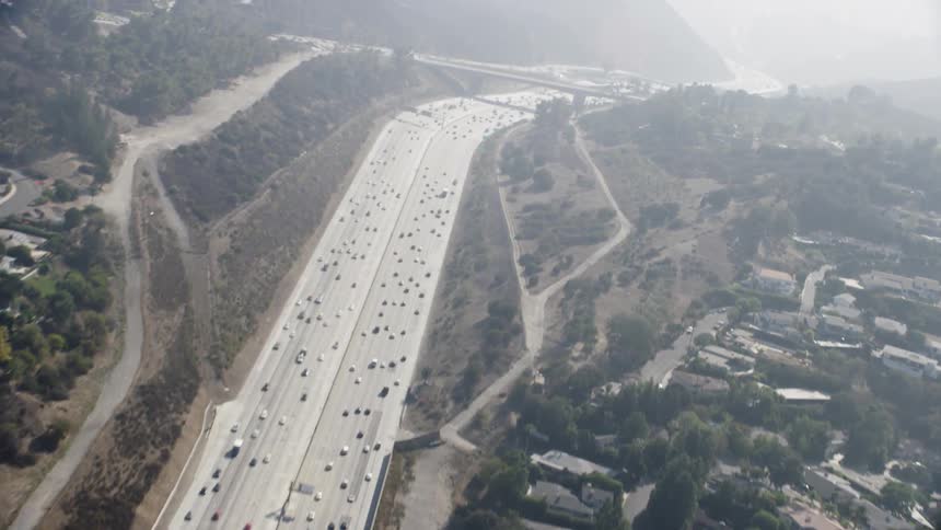 Cars drive on a city highway