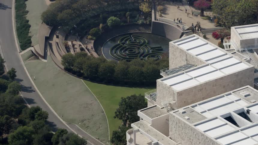 People gather and walk around a building plaza