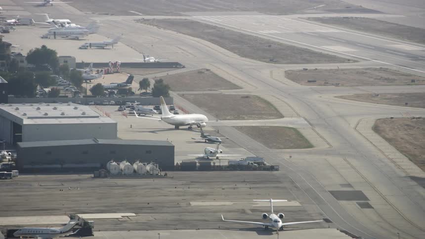 Airplanes sit parked at an airport