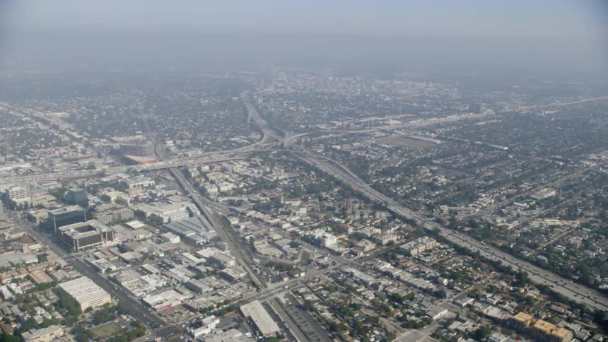 The large city is covered with fog below