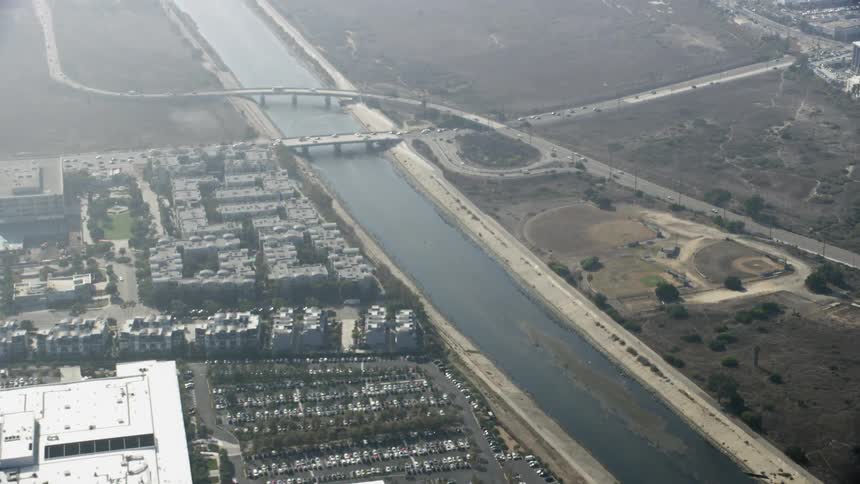 Cars travel over the bridge past the city