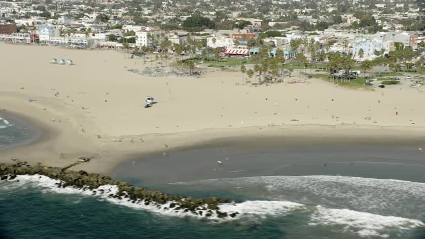 People are enjoying the beach below on a sunny day