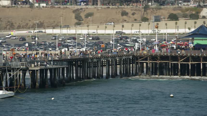 People walk on an ocean pier