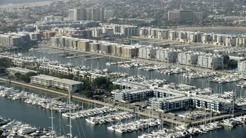 The homes near shore are surrounded by docked boats