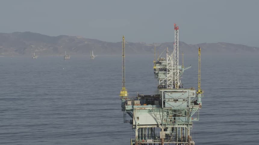 Oil rigs are shown in the ocean