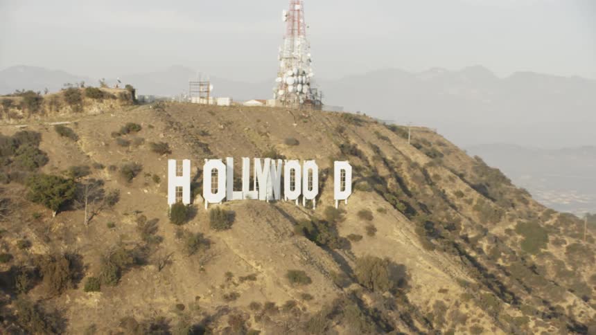 The hollywood sign sits on the top of the hill