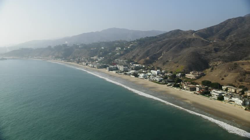 Buildings on a beach next to the ocean