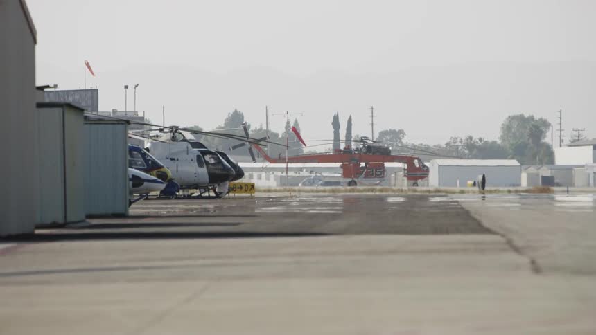 Helicopters are lined up on the runway ahead