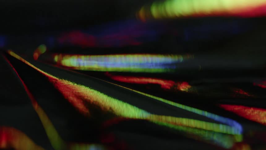 Rainbow lights reflect on a still surface