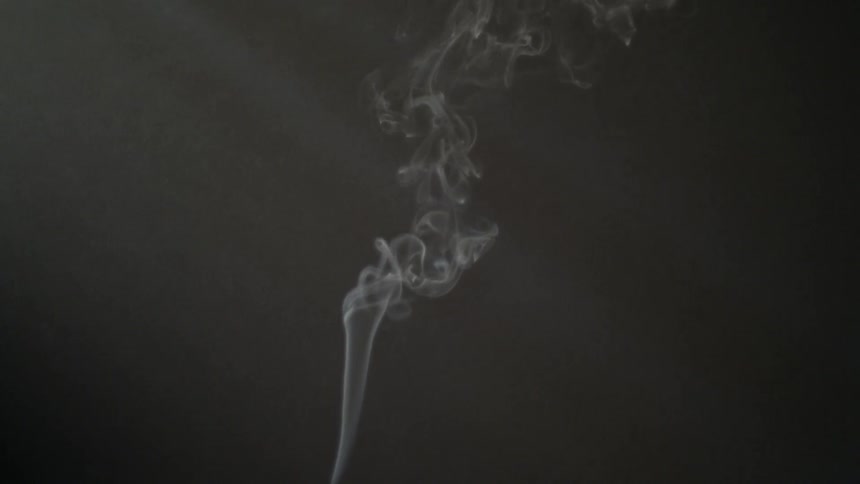 Smoke slowly rises in this dark room