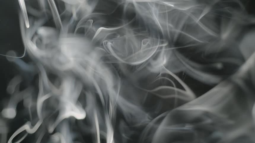 The smoke is filling the dark room in swirls