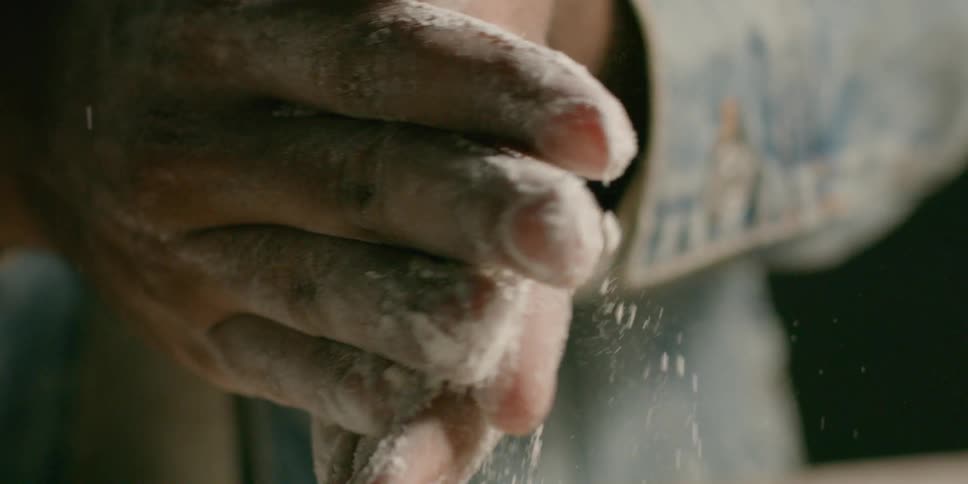 A man rubs flours on his hands