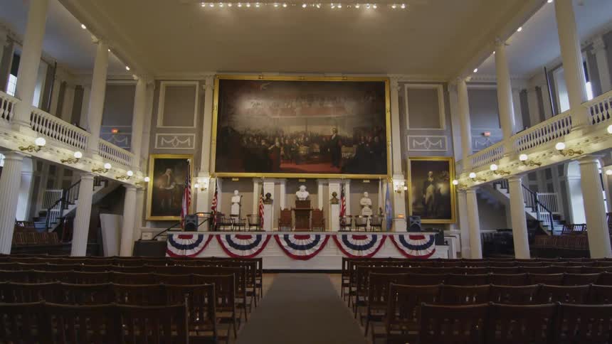 An auditorium with chairs a stage and podium