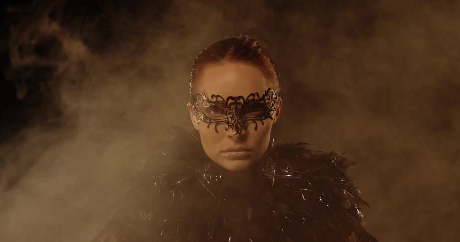 Smoke rises behind and around a woman in costume