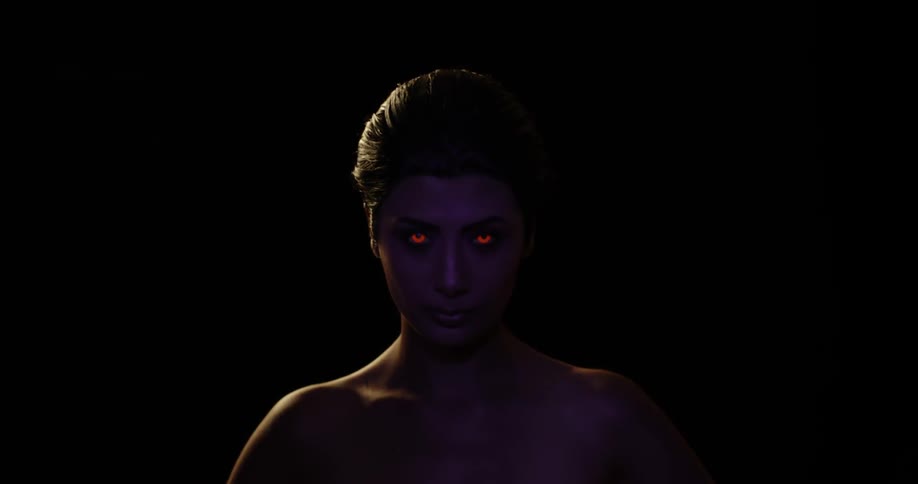 Woman's face with red illuminated eyes