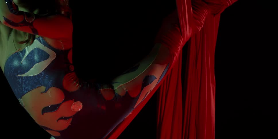 A female acrobat performs using aerial silks
