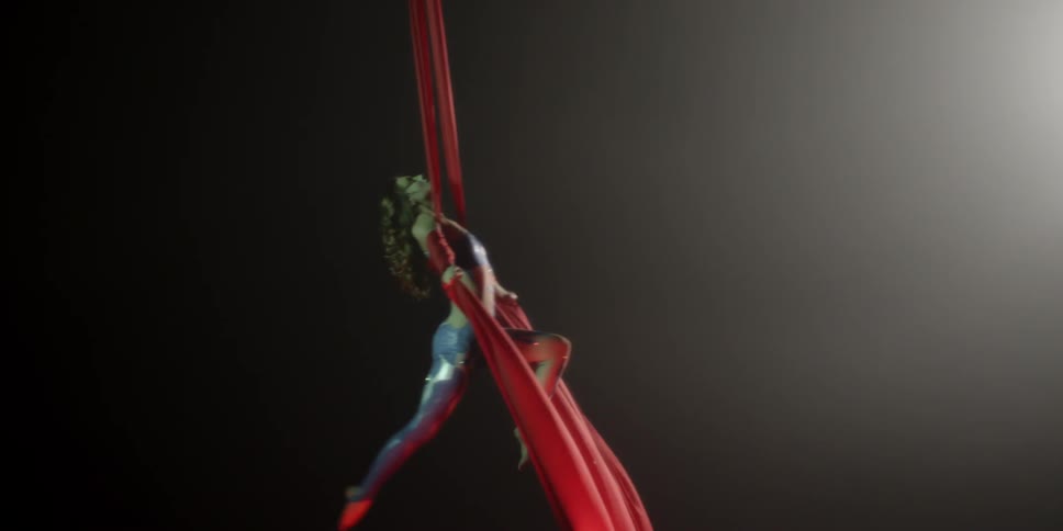 A female acrobat performs an aerial silk routine