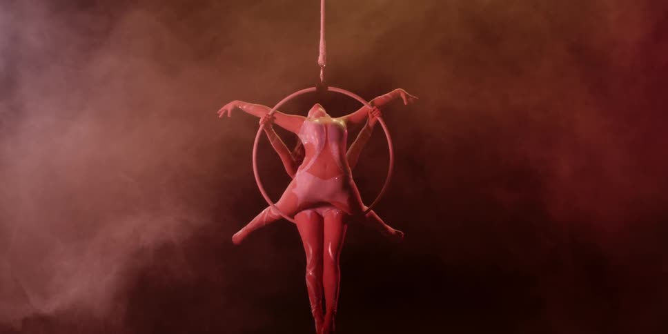 Acrobats spin in a hoop