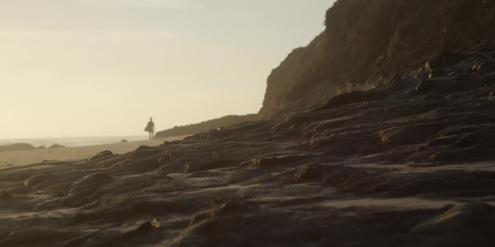 A person walking down the beach