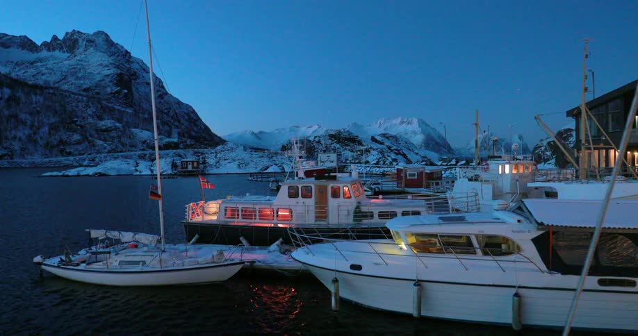 Some of the docked boats have lights on