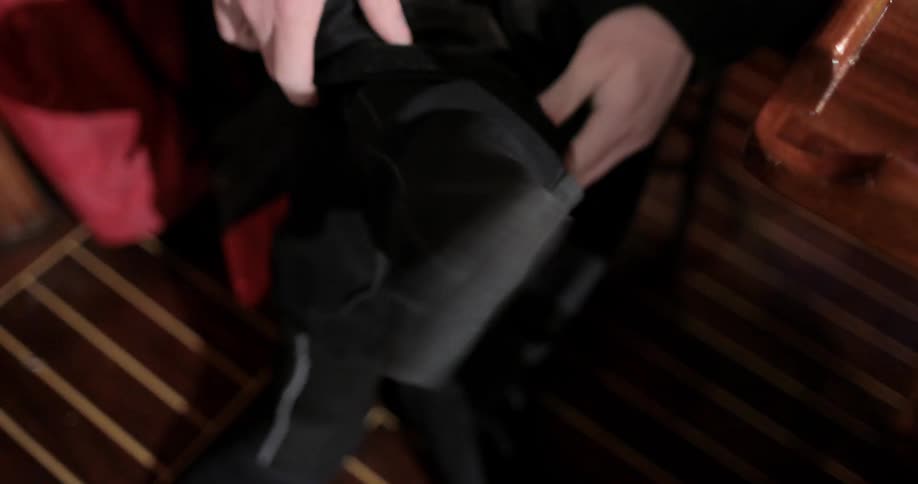 Person fastens a boot and puts it on their foot