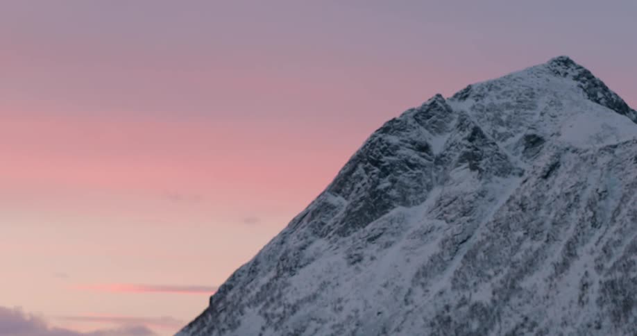 Mountain standing against a colorful sky with a few clouds