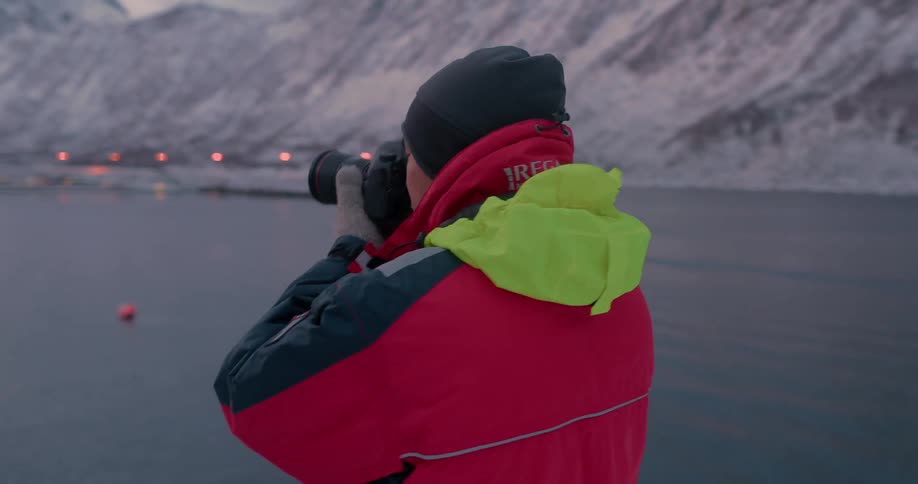 Man on a boat takes pictures with a camera