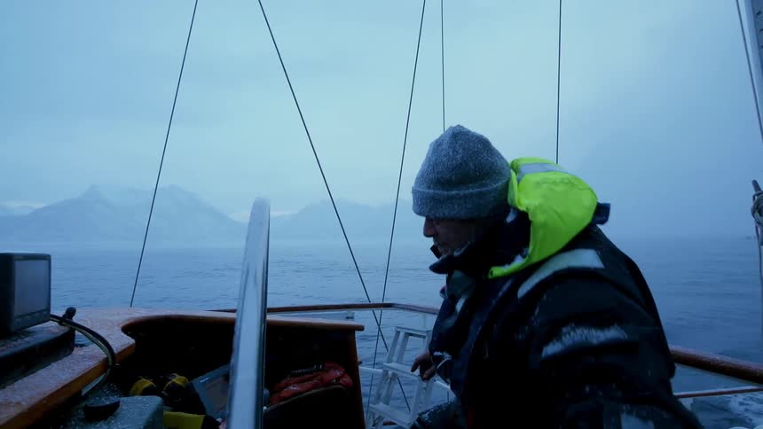 A man sails on a boat