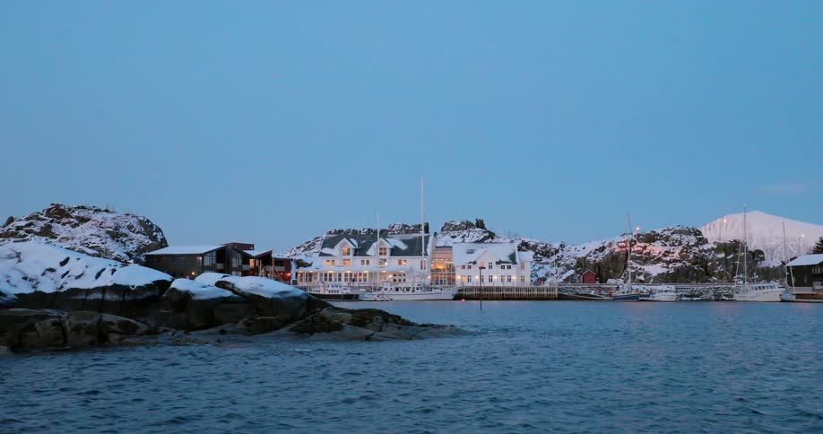 Buildings are illuminated on the shore of a town
