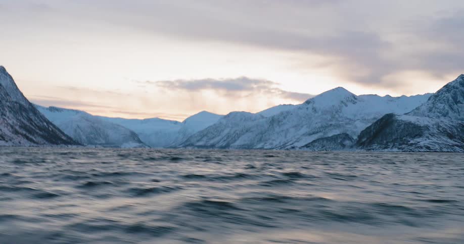 Moving rapidly on the waters on a cold and cloudy day