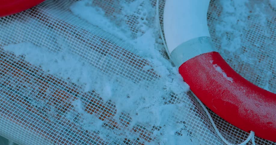 A life preserver sits on a snowy surface