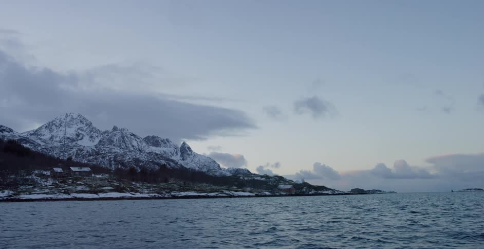 Large body of water surrounded by snowy mountains