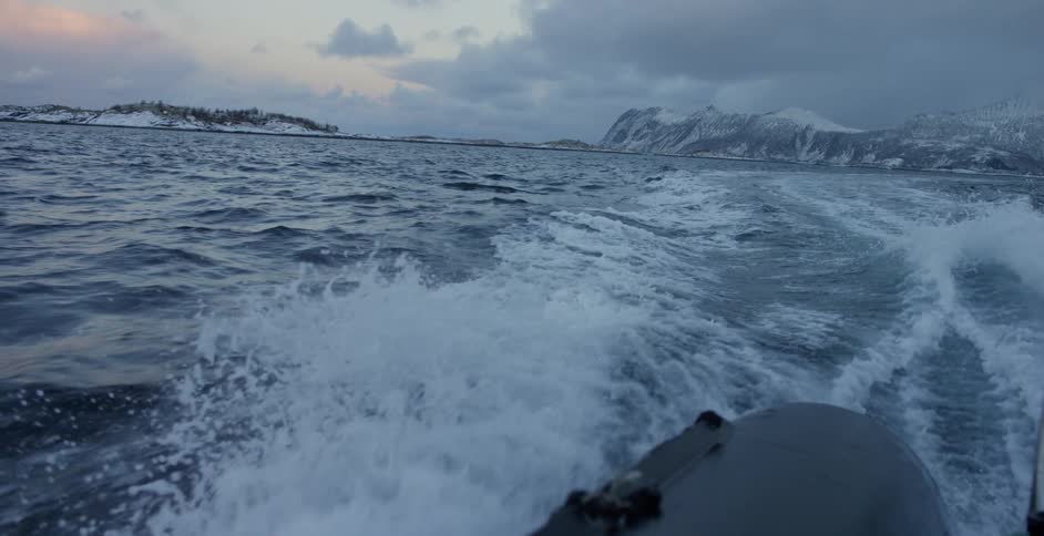 A boat kicks up water behind it