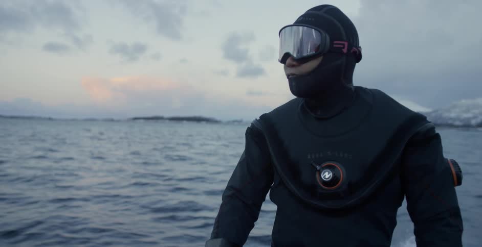 A diver rides on a small powerboat