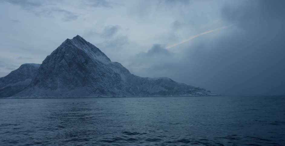 Large body of water surrounded by snowy mountains